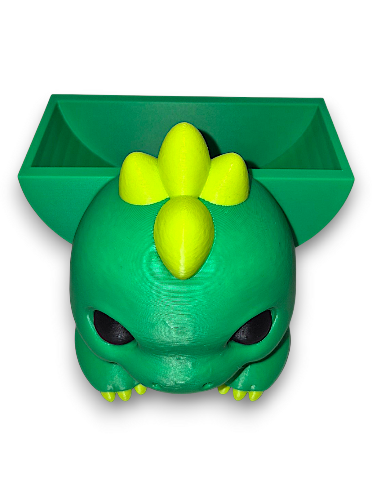 Bright green 3D printed dinosaur sponge holder with yellow spikes and black eyes on a white background
