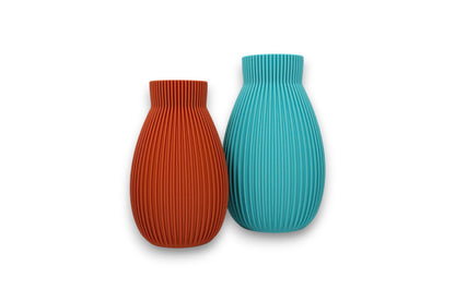 terracotta and turquoise PLA vases – 3D printed with vertical ribbed texture and narrow necks, displayed side by side
