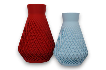 Light blue and red PLA vases – 3D printed with geometric lattice textures and tapered necks, shown side by side

