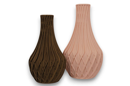 Beige and bronze PLA vases – 3D printed with sculptural leaf and geometric textures, shown side by side

