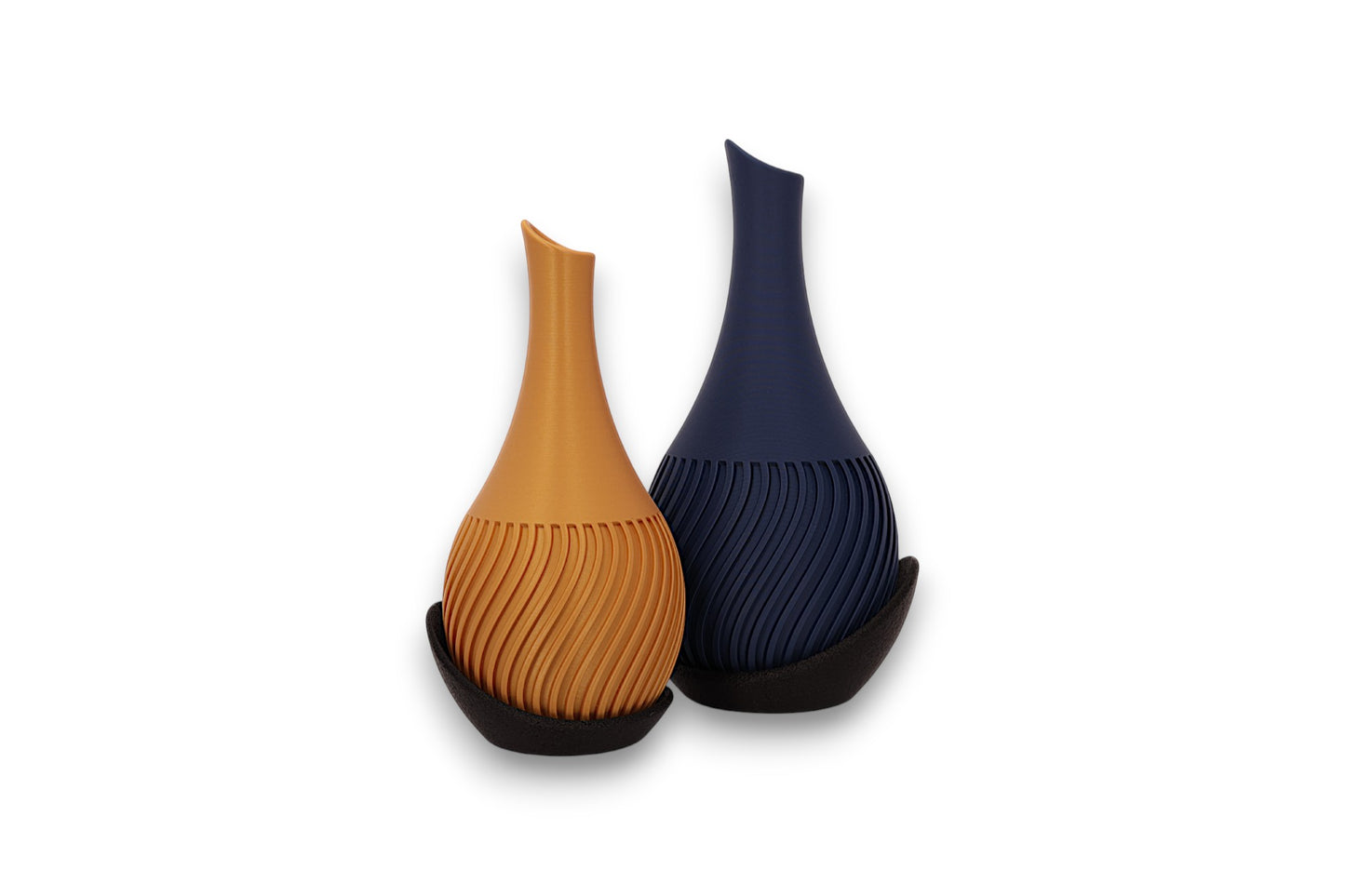 Gold and dark blue PLA vases – 3D printed with spiral ribbed texture and asymmetrical openings, each cradled in black curved base

