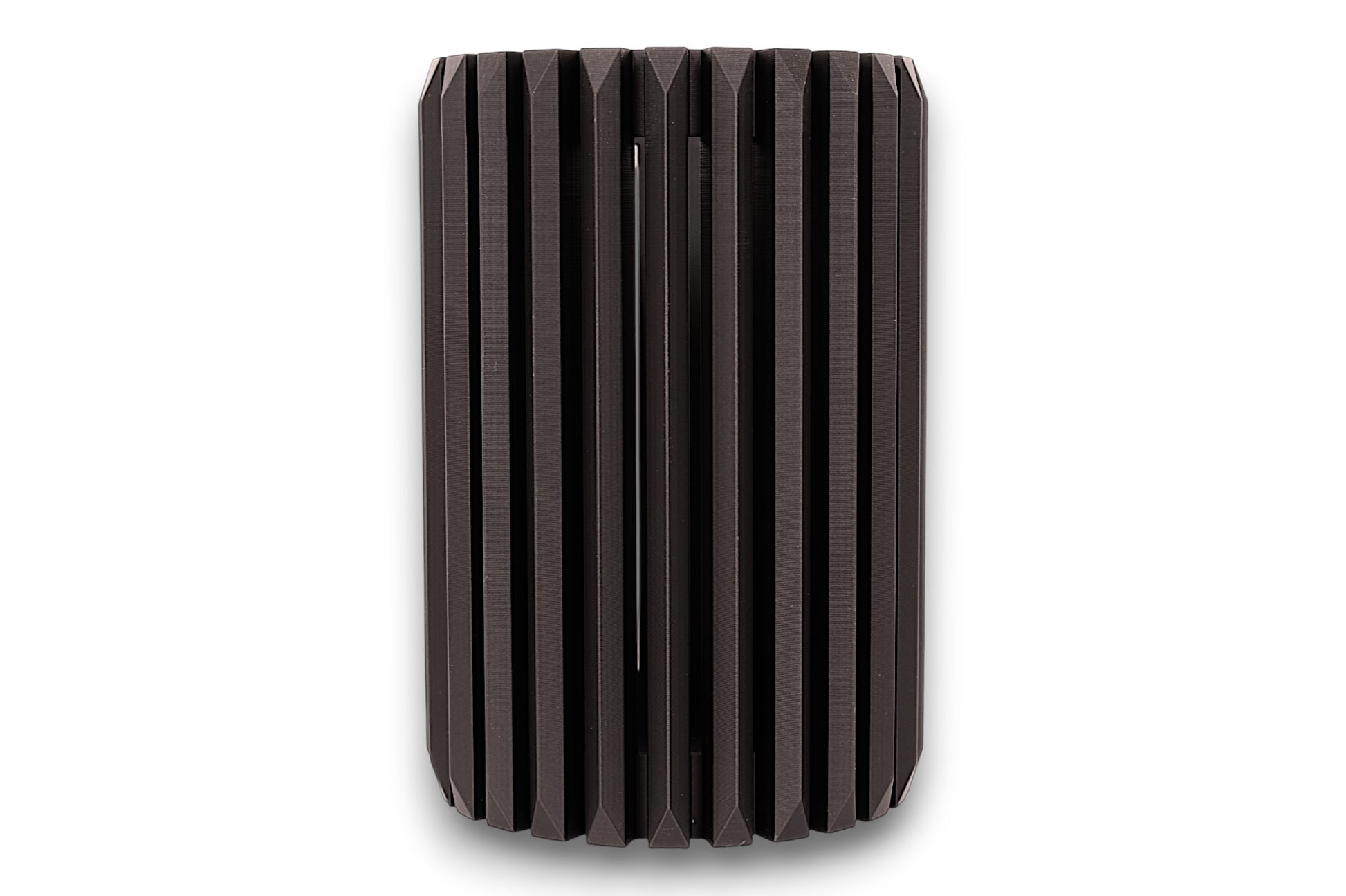 Black cylindrical vase with ribbed texture on a white background