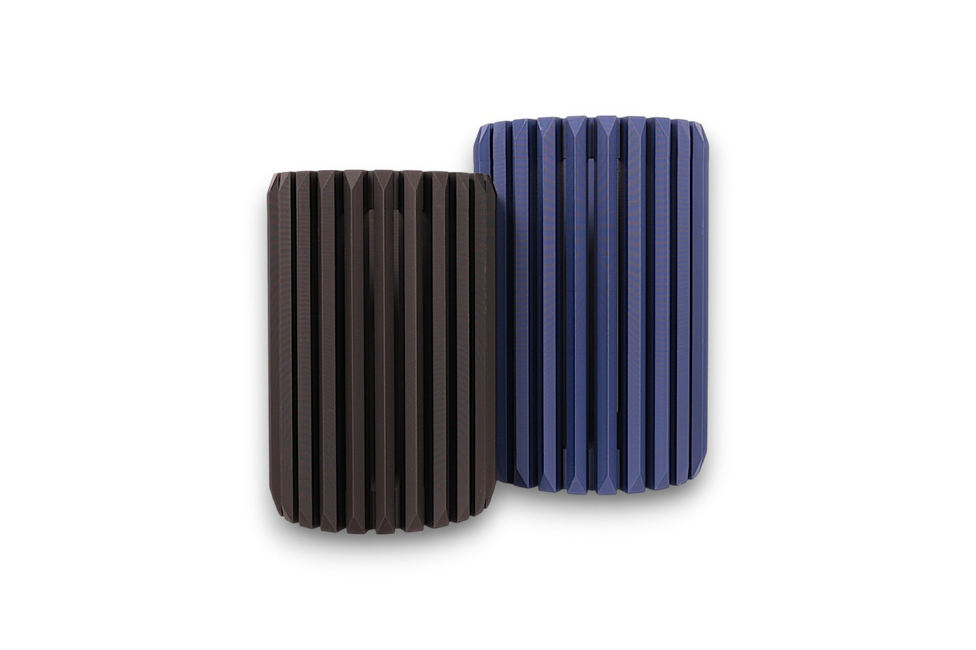 blue and black cylindrical vases with textured surfaces on a white background
