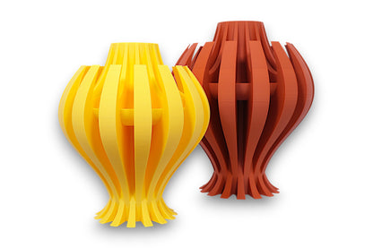 Yellow and reddish-brown PLA vases – 3D printed with curved vertical slats and symmetrical flared forms, displayed side by side
