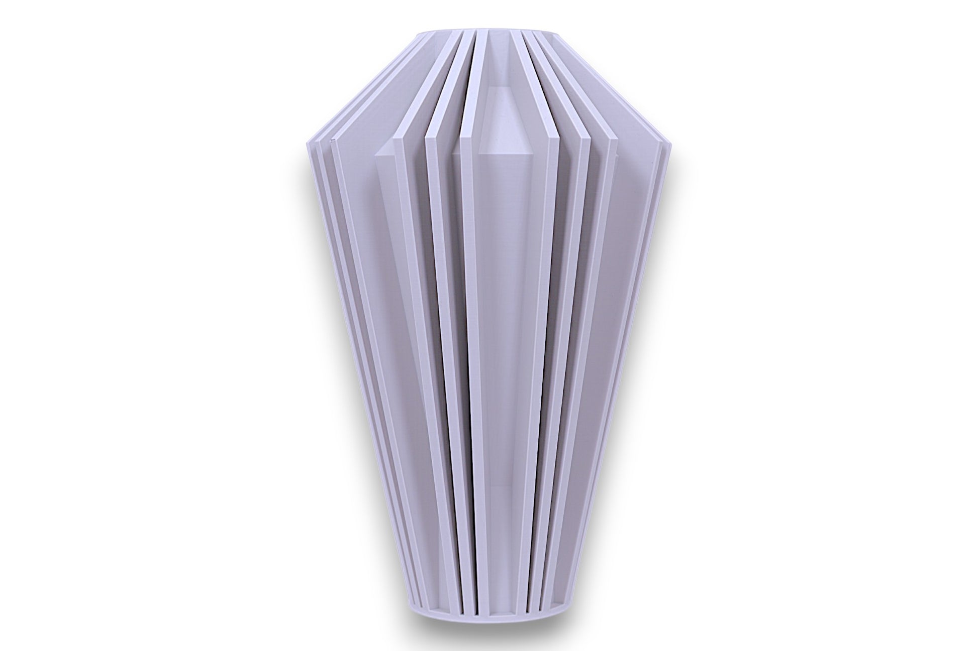 A light gray, geometrically intricate vase with a conical shape and multiple vertical ridges extending from the top to the bottom. The vase has a hollow cylindrical opening at the top and a pointed base. The design features a series of evenly spaced, angular fins that create a visually striking pattern, giving the vase a modern and artistic appearance.