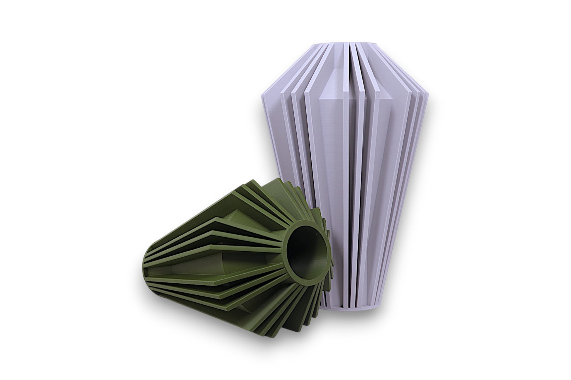 White and green PLA vases – 3D printed with faceted vertical ridges and hollow centers, shown upright and sideways for contrast