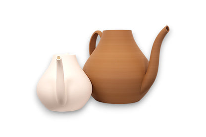 Two  watering cans, one white and one tan, on a white background