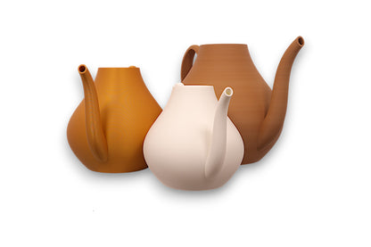 gold, ivory white, and brown PLA watering cans – 3D printed with sculptural bodies and curved spouts, arranged in staggered layout


