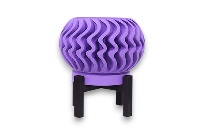 Purple PLA planter – 3D printed with spherical body and vertical wavy texture, elevated on black four-legged stand
