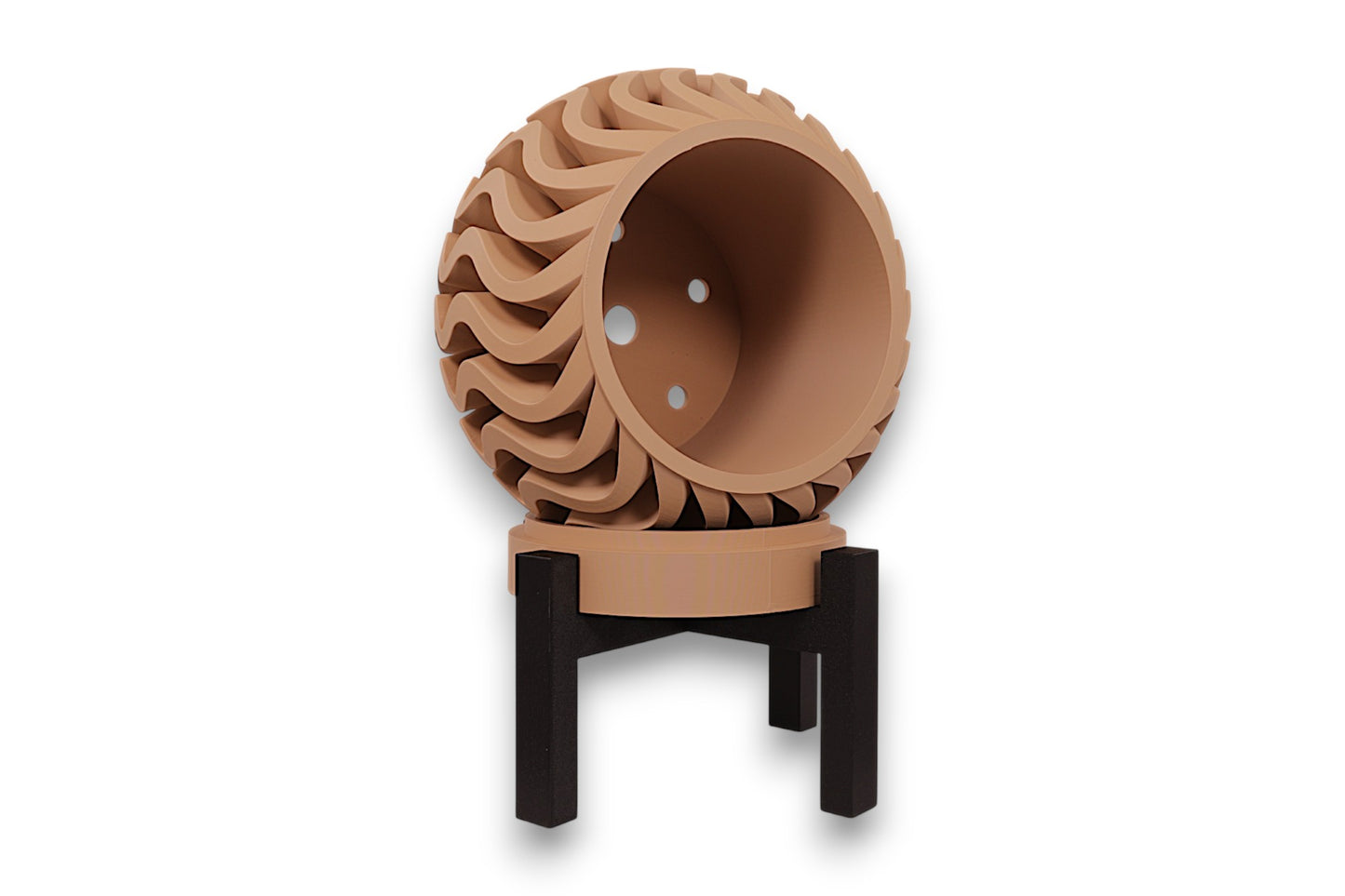 desert tan PLA planter – 3D printed with bulbous body and undulating vertical ridges, mounted on black four-legged stand
