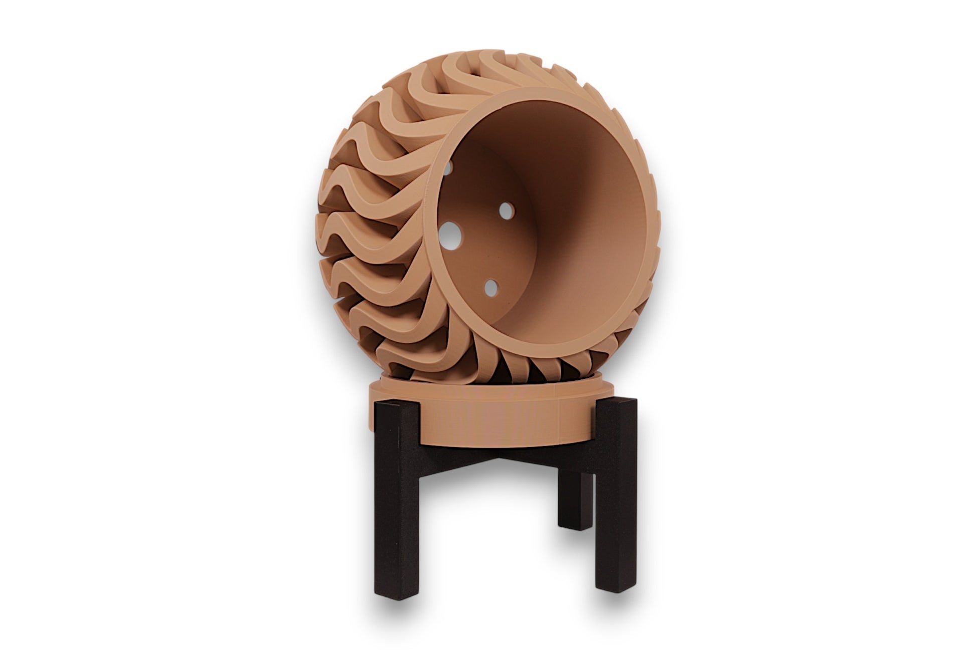 desert tan PLA planter – 3D printed with bulbous body and undulating vertical ridges, mounted on black four-legged stand

