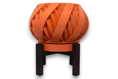 Terracotta PLA planter – 3D printed with interwoven ribbon texture and bulbous form, elevated on black four-legged stand
