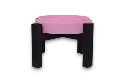 Pink drip tray with black legs on a white background