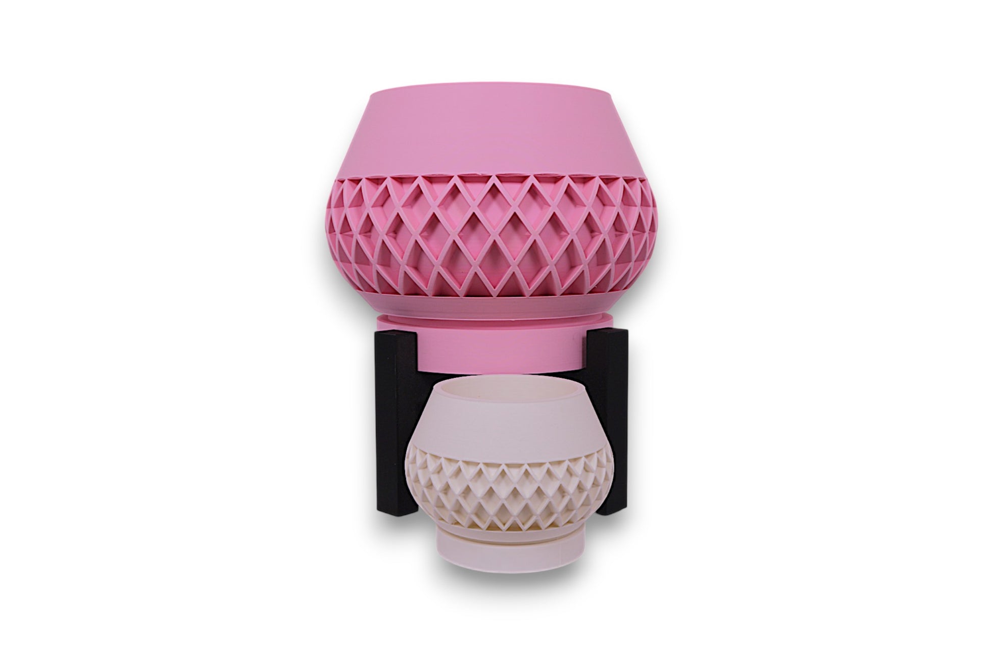 Pink and white PLA planters – 3D printed with diamond lattice textures and bowl-shaped forms, stacked vertically in black stand
