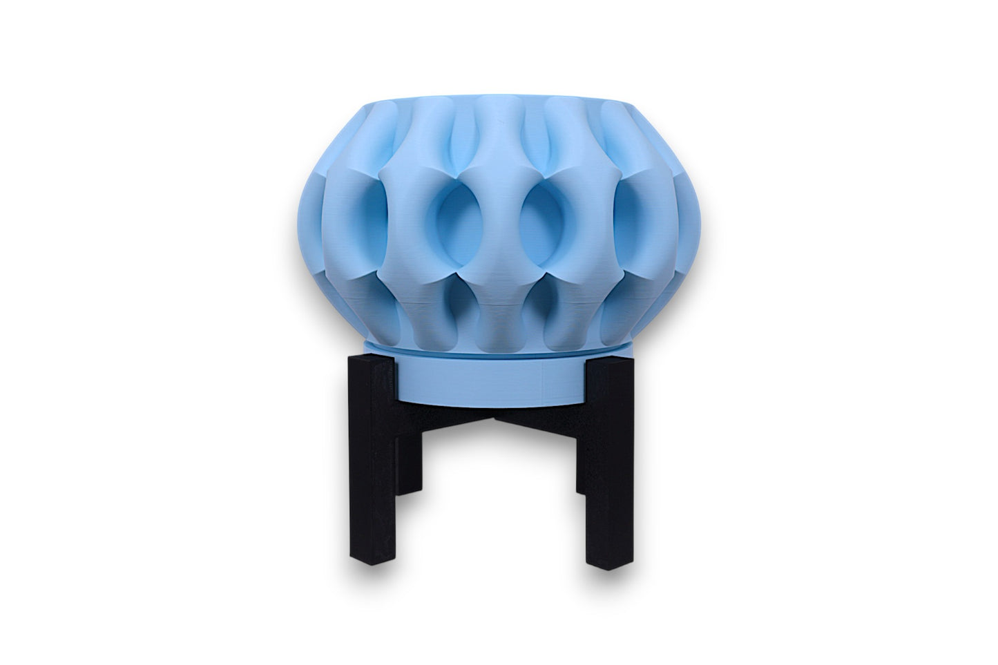 Light blue PLA planter – 3D printed with bulbous body and deep concave indentations, elevated on black four-legged stand
