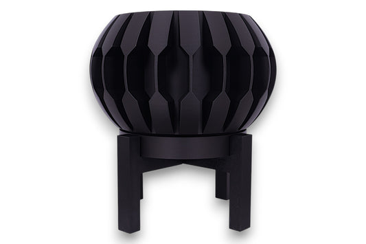 Black PLA planter – 3D printed with spherical body and vertical blade-like ridges, mounted on black four-legged stand
