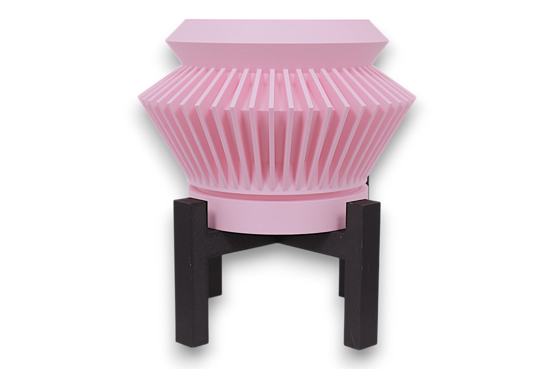 Pink PLA planter – 3D printed with flared body and vertical pleated ridges, mounted on black four-legged stand

