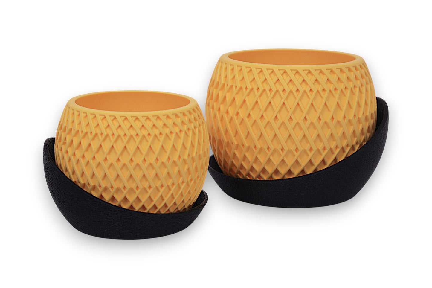 Set of two yellow-orange PLA planters – 3D printed with diamond lattice texture, partially encased in curved black bases
