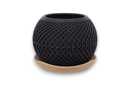Black textured planter with gold base on a white background