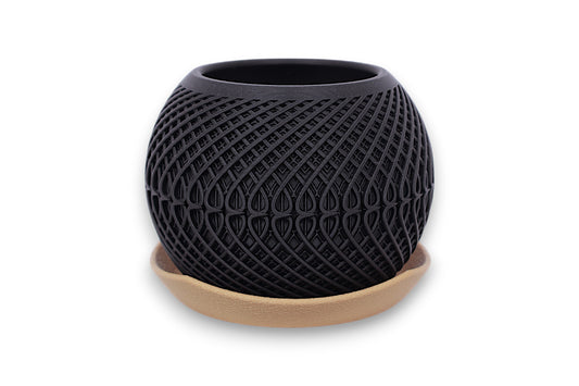 Black textured planter with gold base on a white background