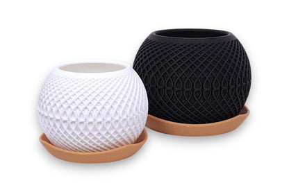 White and black PLA planters – 3D printed with diamond and teardrop textures, each placed on light brown saucer