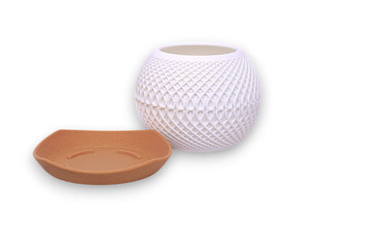 White PLA planter – 3D printed with diamond lattice texture, placed on shallow brown saucer
