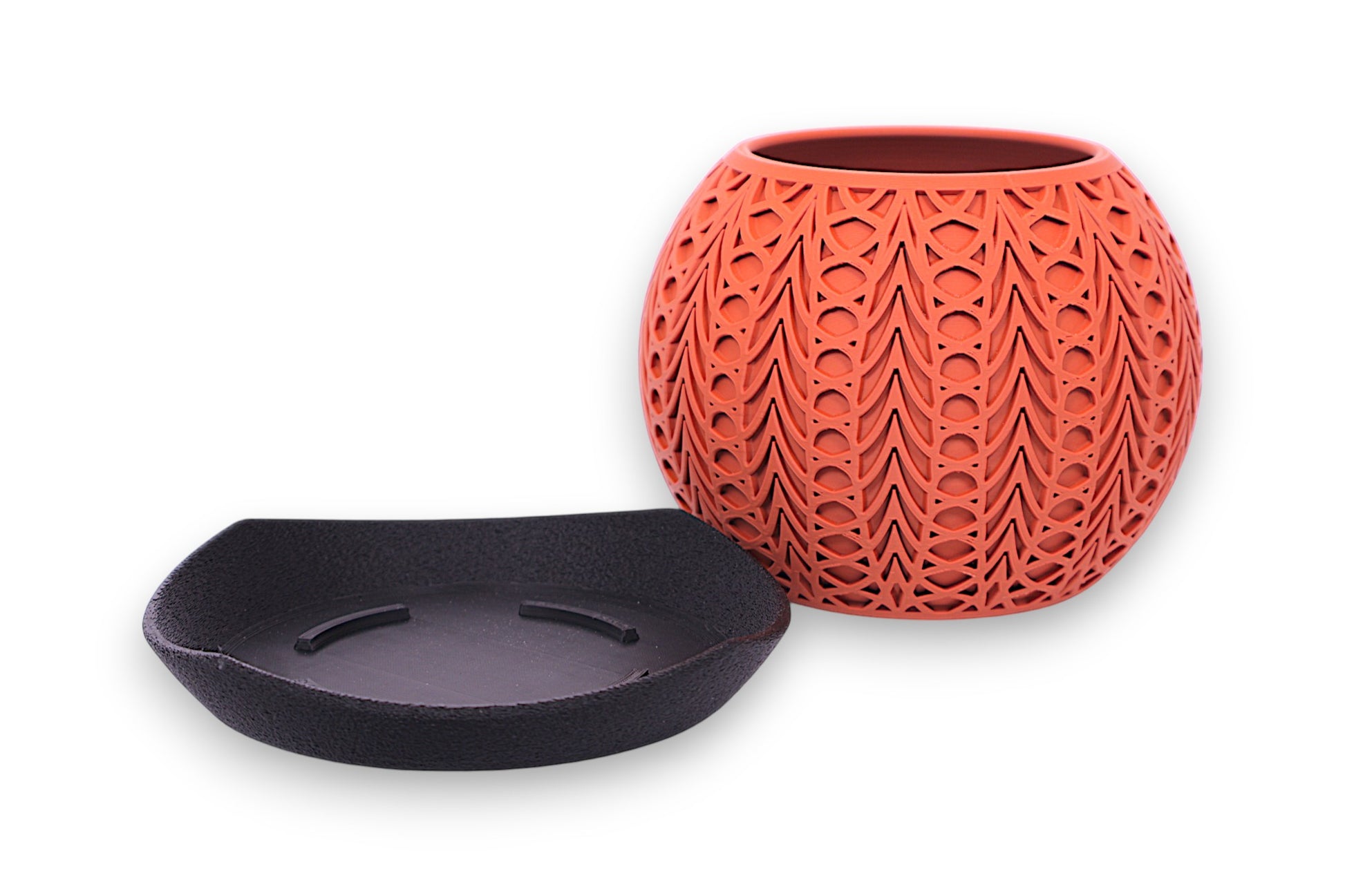 terracotta textured pot with black saucer on a white background