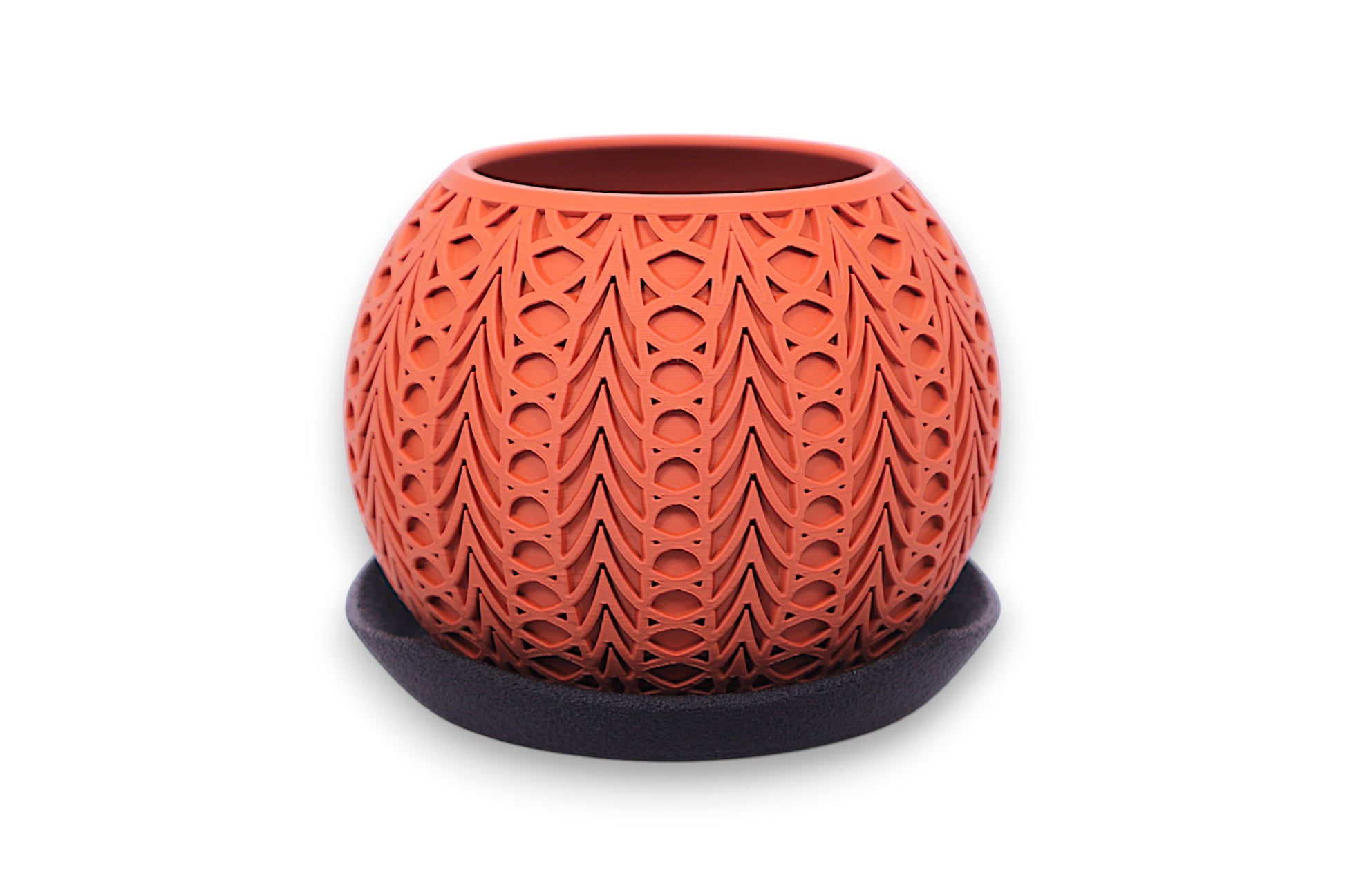 Terracotta PLA planter – 3D printed with symmetrical teardrop and oval cutouts, displayed on dark saucer
