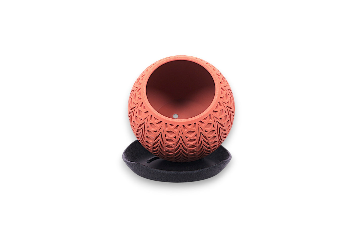 Decorative terracotta pot with textured design on a white background
