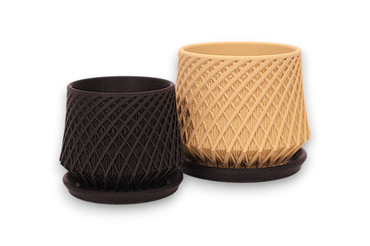 Black and beige PLA decorative planter – 3D printed with spiral mesh texture, shown side by side on matching bases
