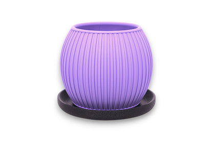 Purple PLA decorative planter – 3D printed with vertical ribbed texture and tapered shape, placed on black circular base
