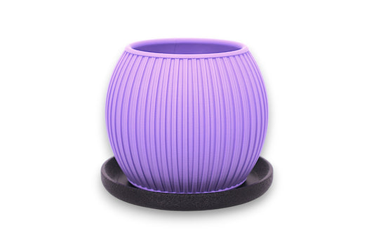 Purple PLA decorative planter – 3D printed with vertical ribbed texture and tapered shape, placed on black circular base
