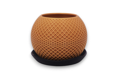 Gold PLA decorative planter – 3D printed with diamond lattice texture, placed on black saucer
