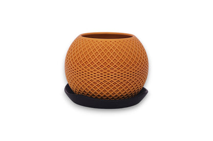 Gold PLA decorative planter – 3D printed with diamond lattice texture, placed on black saucer
