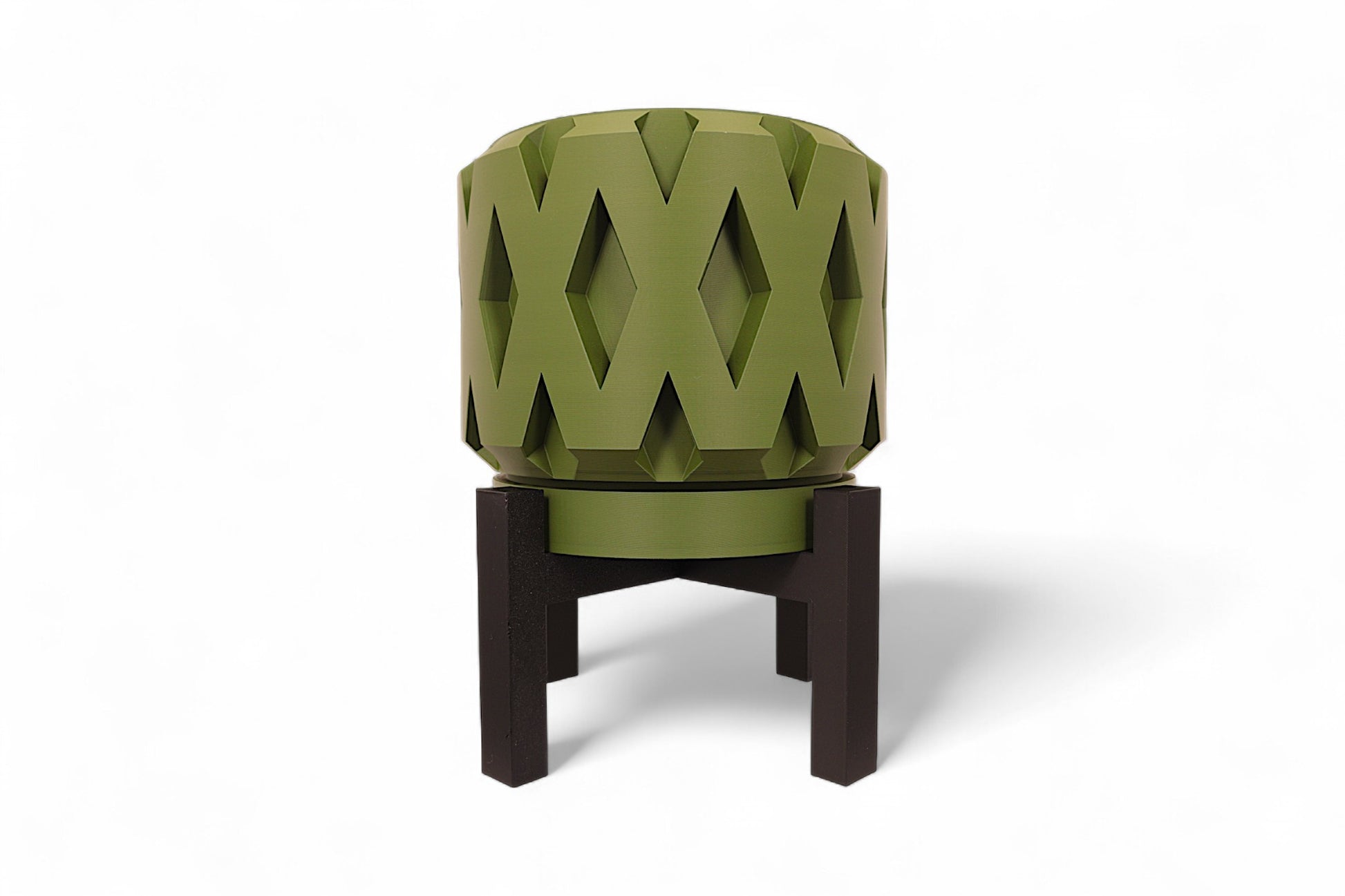 Green planter with notched rim and dark interior mounted on black four legged stand