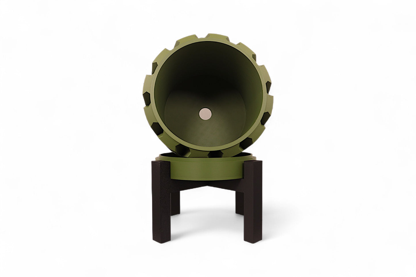 Green planter with notched rim and dark interior mounted on black tripod stand