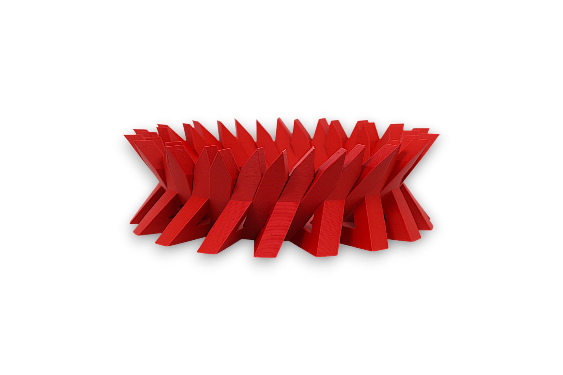 Red catch-all tray with interlocking angular fins in a circular zigzag pattern