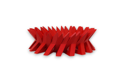 Red catch-all tray with interlocking angular fins in a circular zigzag pattern
