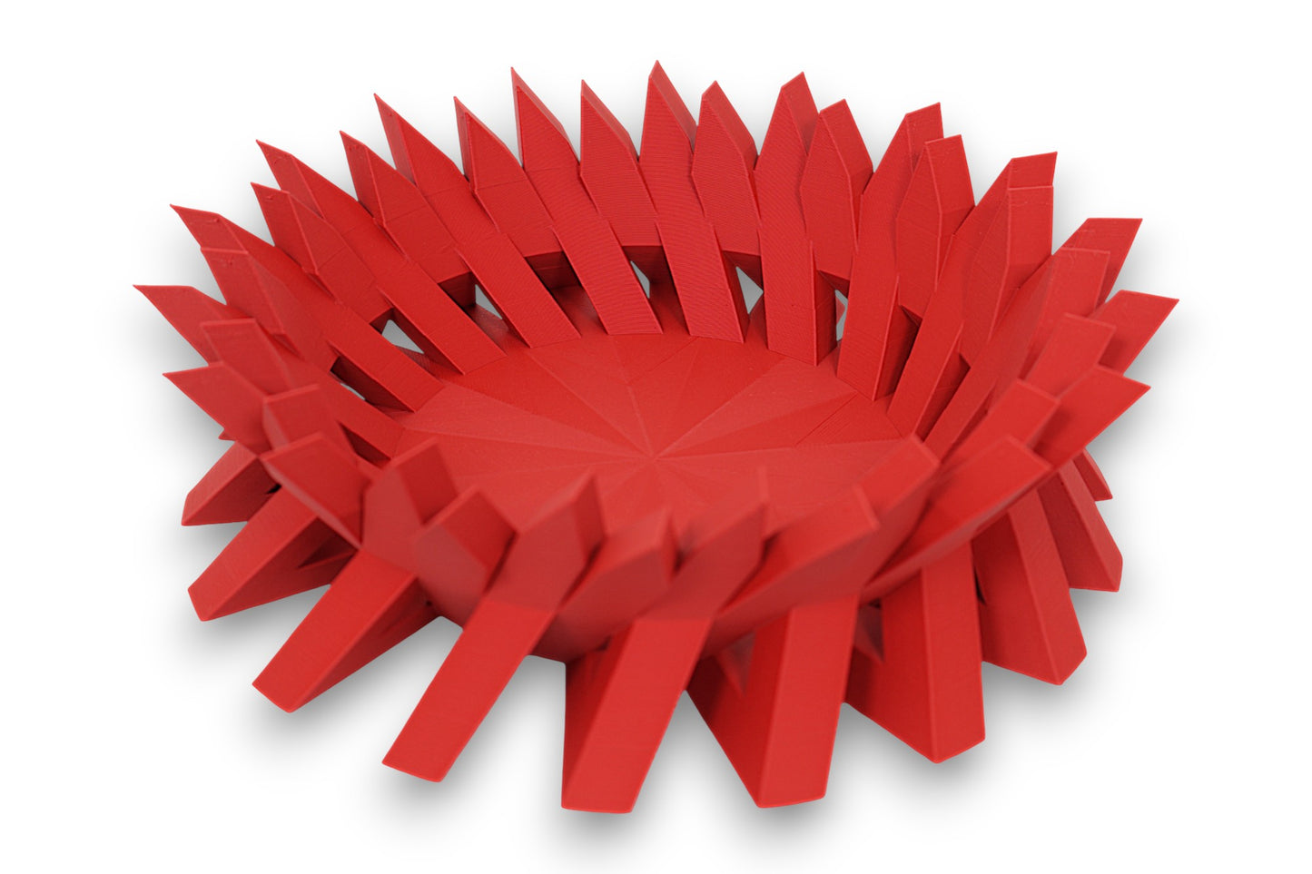 Red catch-all tray with upward-pointing triangular spikes arranged in a radial layout