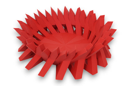Red catch-all tray with upward-pointing triangular spikes arranged in a radial layout