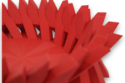 Red catch-all tray with pointed vertical fins and faceted starburst base