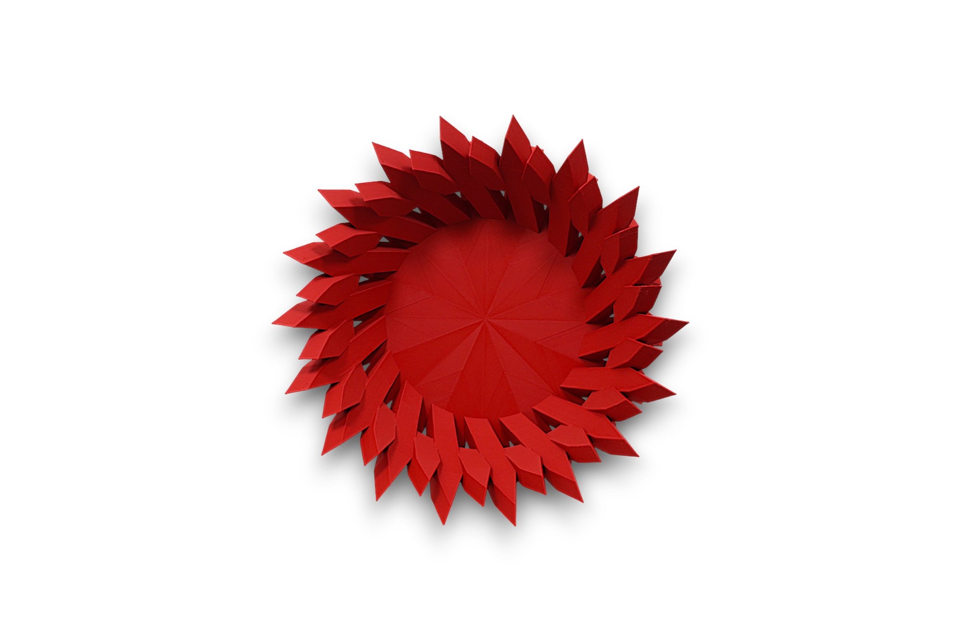 Red catch-all tray with folded petal-like spikes radiating from circular center