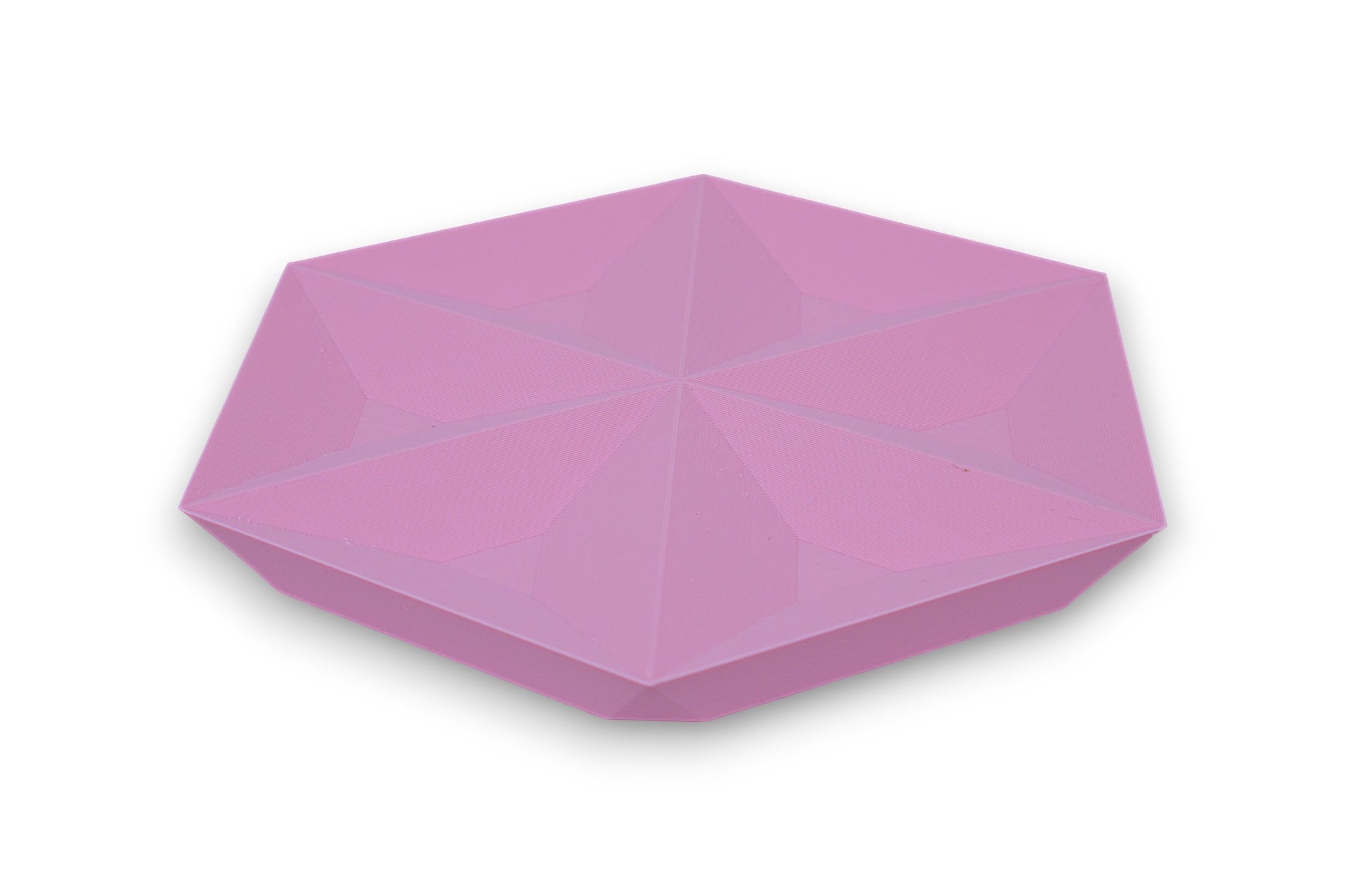Pink hexagonal catch-all tray with raised triangular facets on top surface