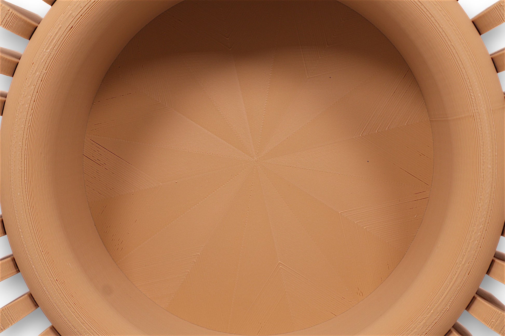 catch-all tray with smooth concave interior and radial vertical ridges