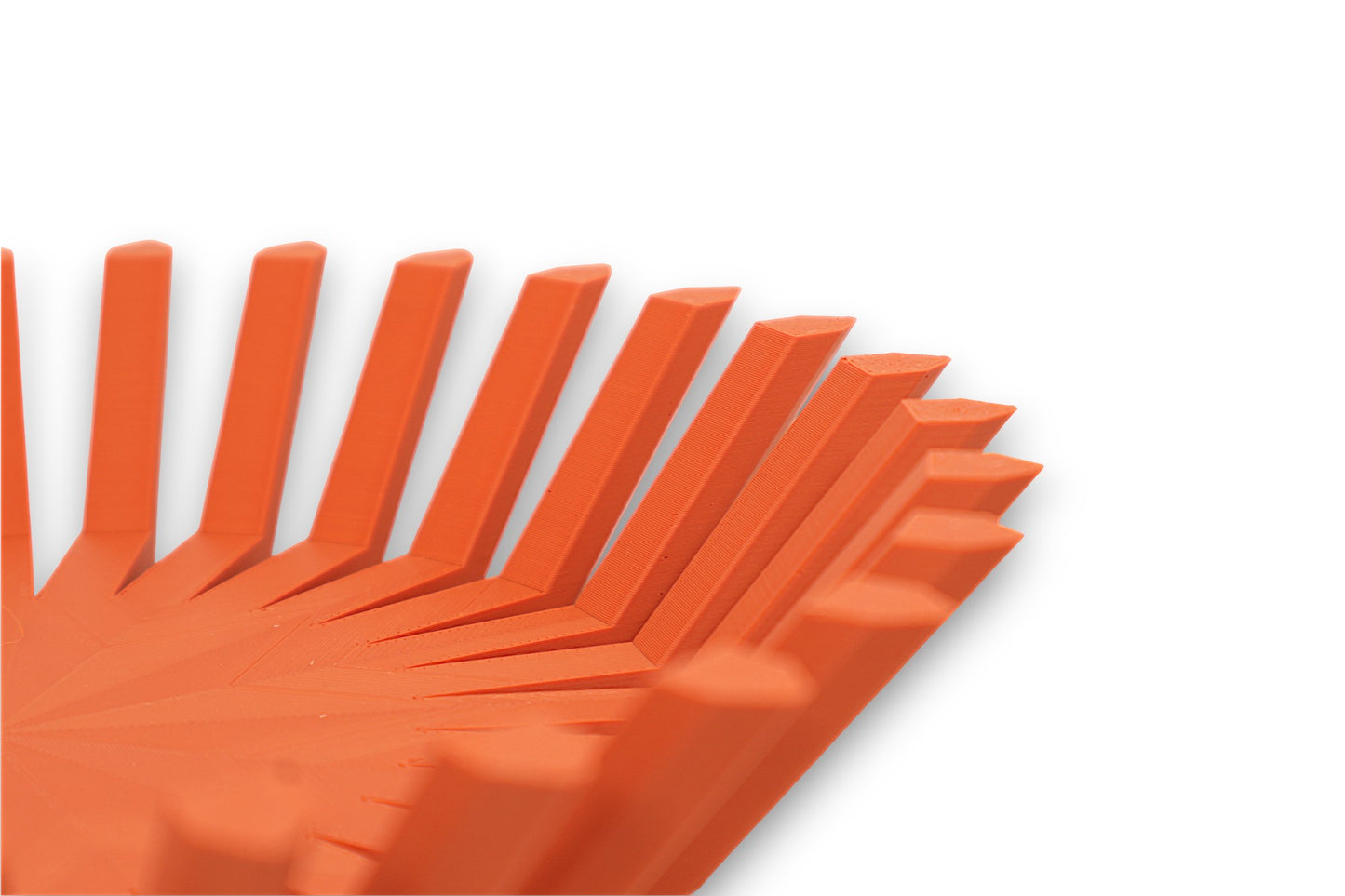Terra cotta catch-all tray with sharp radial fins and circular base, symmetrical starburst design