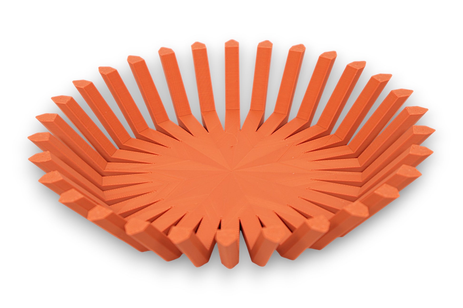Terra cotta catch-all tray with circular base and vertical rectangular ridges around perimeter