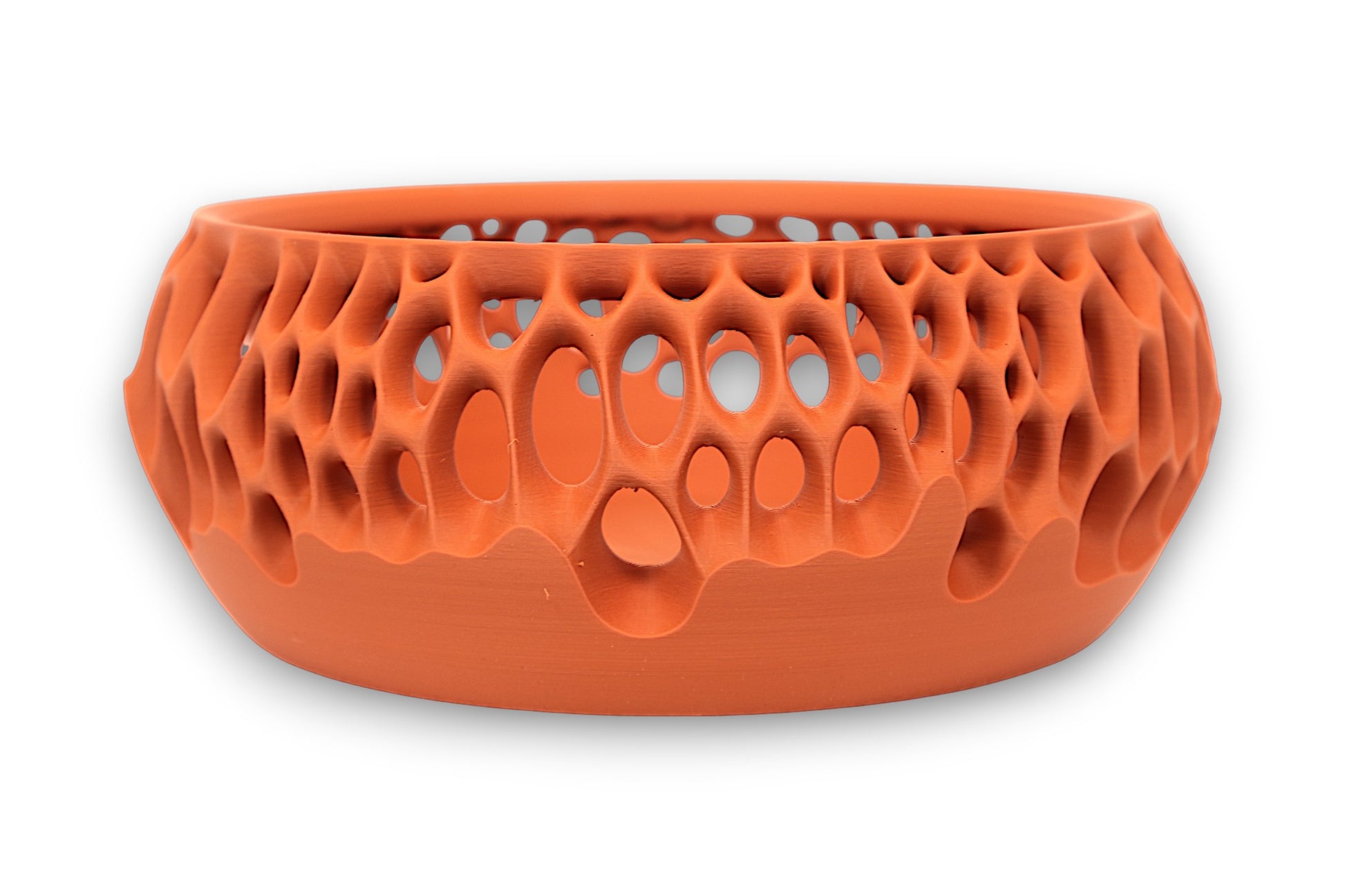 Terracotta catch-all tray with oval and circular cutouts forming a porous upper half