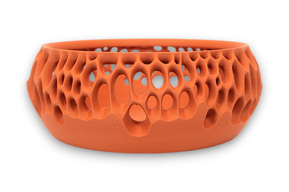 Terracotta catch-all tray with oval and circular cutouts forming a porous upper half