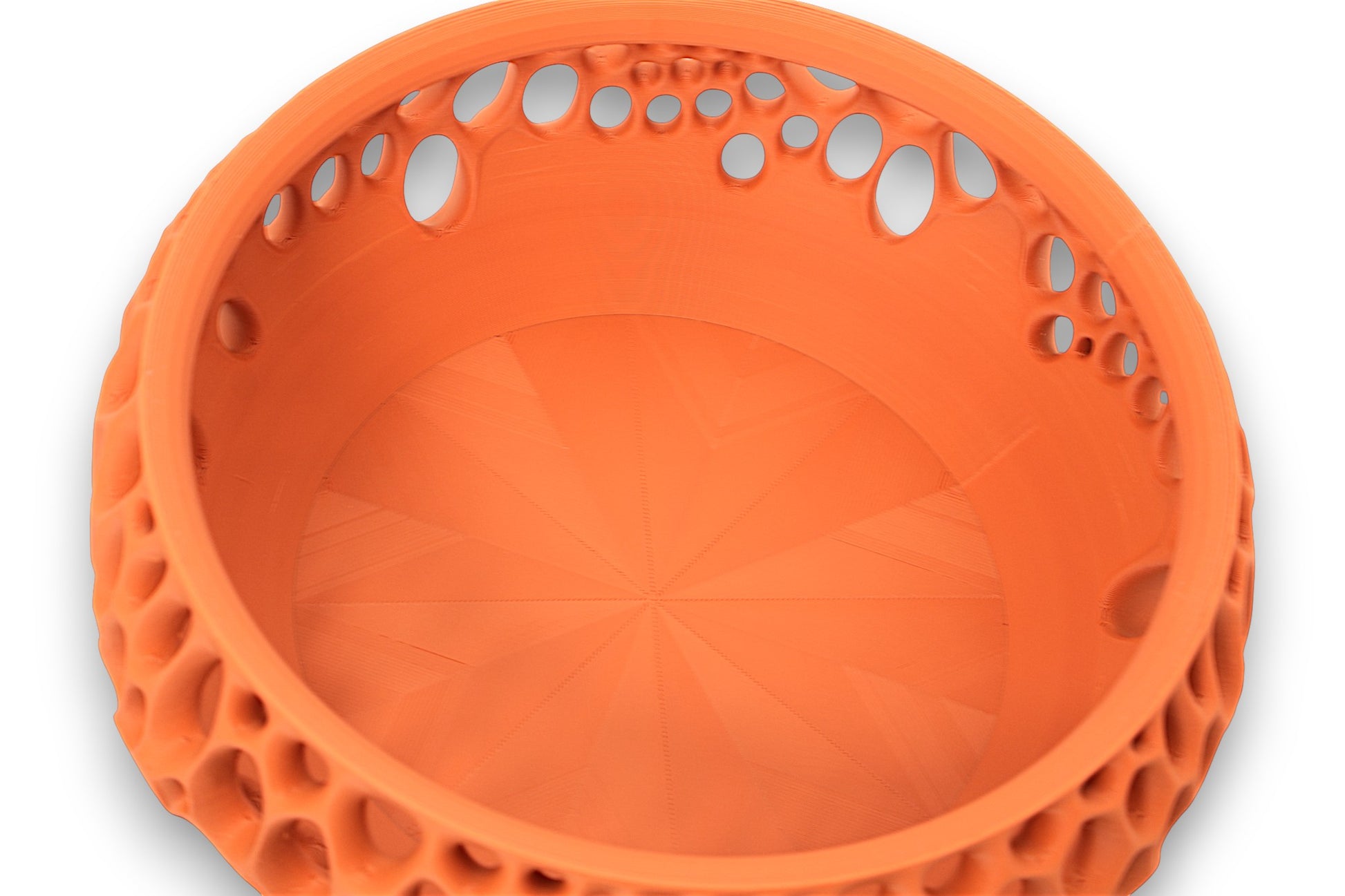 Terracotta catch-all tray with radial base pattern and oval cutouts along inner rim