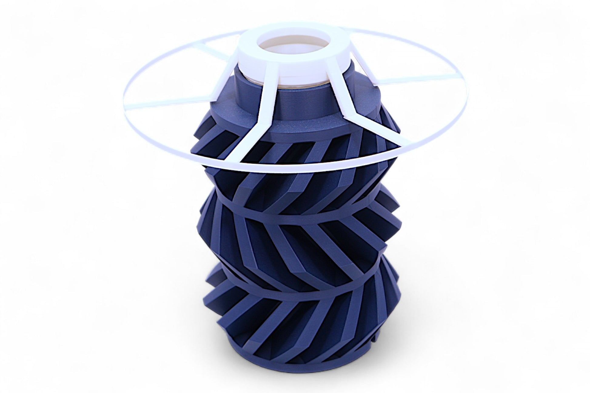 Lamp base component – dark blue helical rotor with translucent radial disc, shown from above
